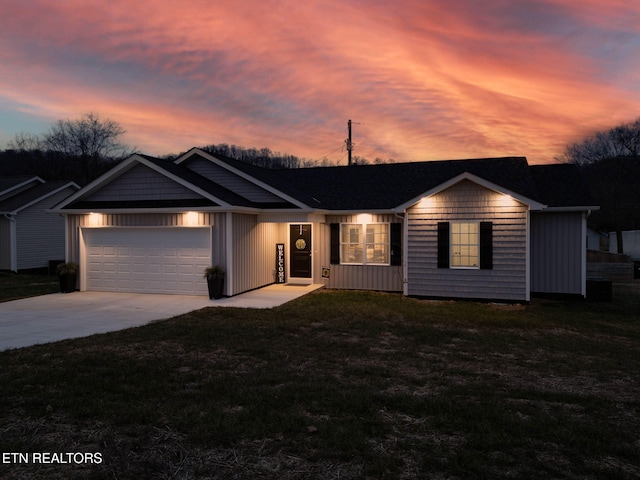 ranch-style home featuring a garage and a yard