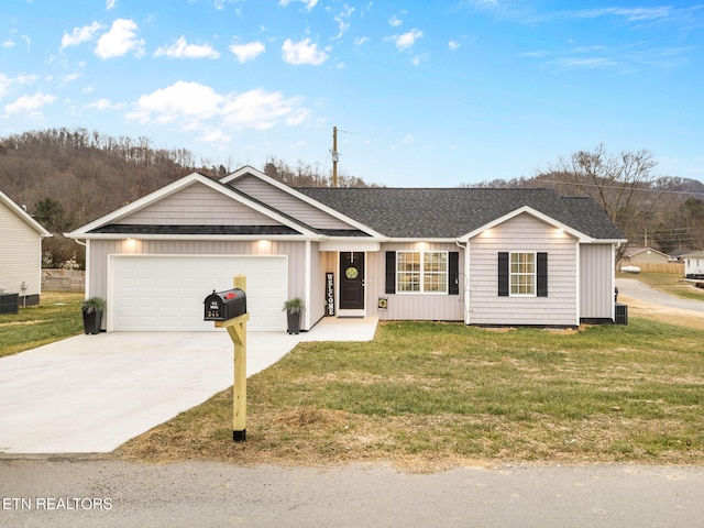 ranch-style house featuring central AC, a garage, and a front lawn