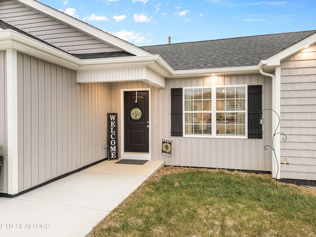 doorway to property with a yard