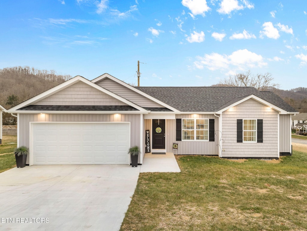 view of front of house with a garage and a front lawn