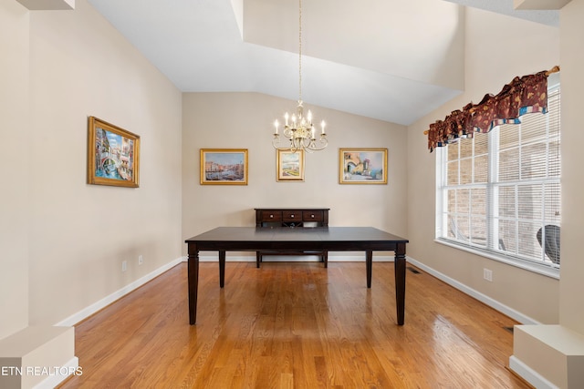 home office featuring a chandelier, lofted ceiling, and wood-type flooring