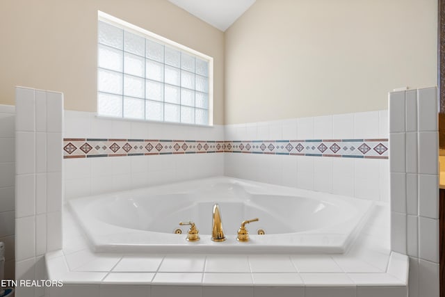 bathroom with tiled bath