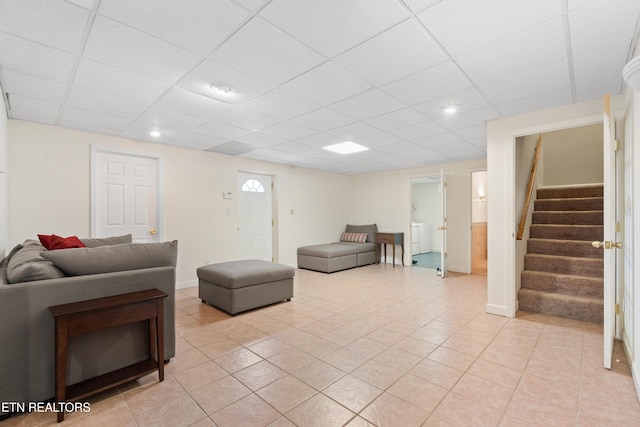 tiled living room featuring a drop ceiling