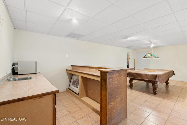 rec room with a paneled ceiling, sink, light tile patterned floors, and pool table