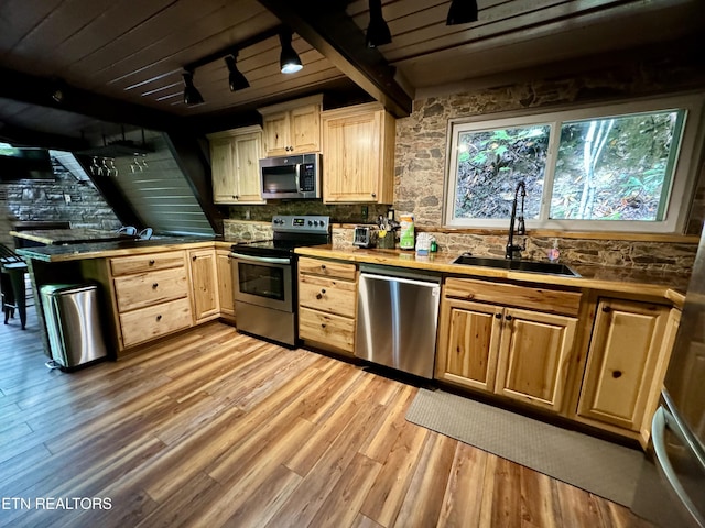 kitchen featuring sink, wood ceiling, stainless steel appliances, and light hardwood / wood-style flooring