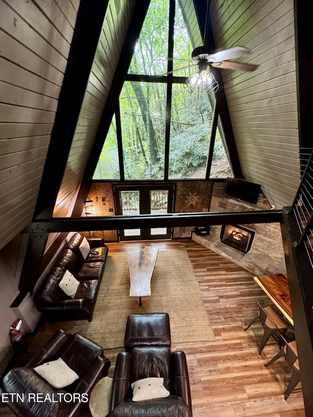 unfurnished sunroom featuring ceiling fan and lofted ceiling