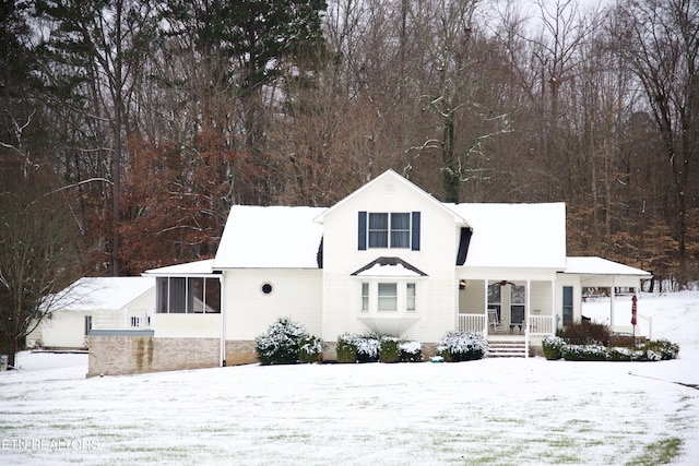 view of front of property featuring covered porch and a sunroom