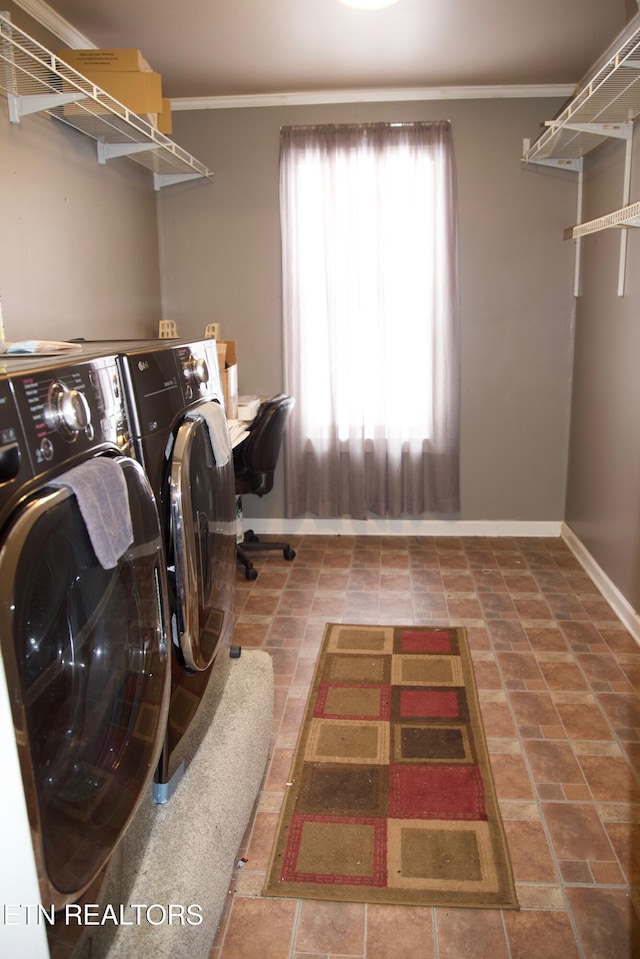 laundry room with crown molding and washer and clothes dryer