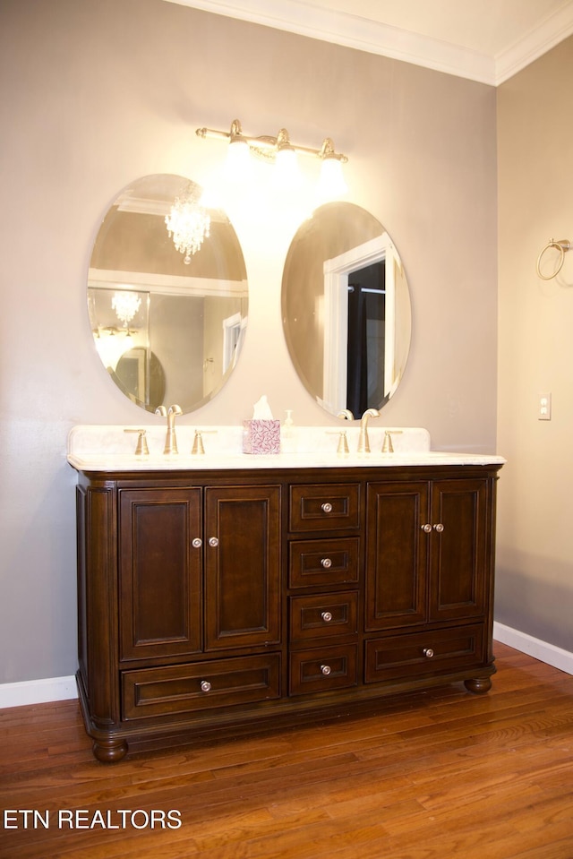 bathroom with vanity, hardwood / wood-style floors, and ornamental molding