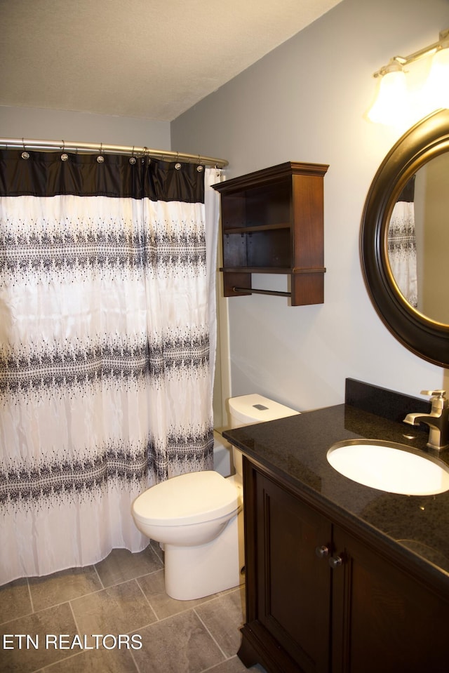 full bathroom featuring vanity, shower / tub combo, and toilet