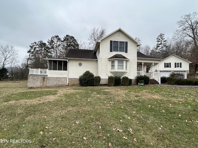 view of front facade with a front lawn, a sunroom, and a porch