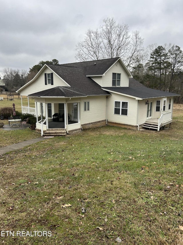 back of house with a lawn and a porch