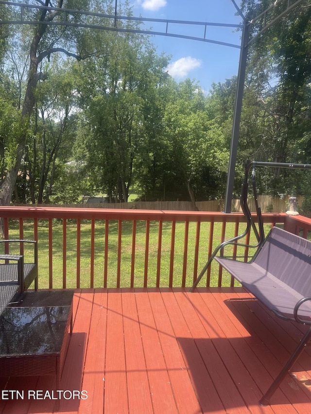 wooden deck featuring a yard