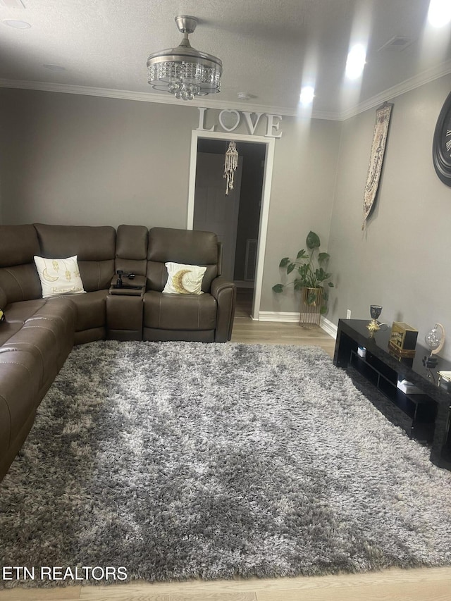 living room featuring crown molding, a textured ceiling, and hardwood / wood-style flooring