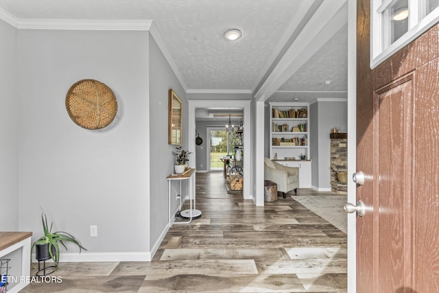 foyer entrance with a textured ceiling, crown molding, and wood-type flooring