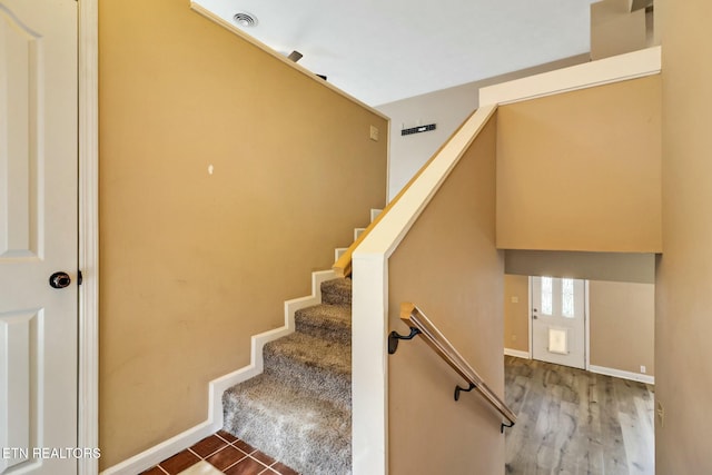 stairs featuring hardwood / wood-style floors