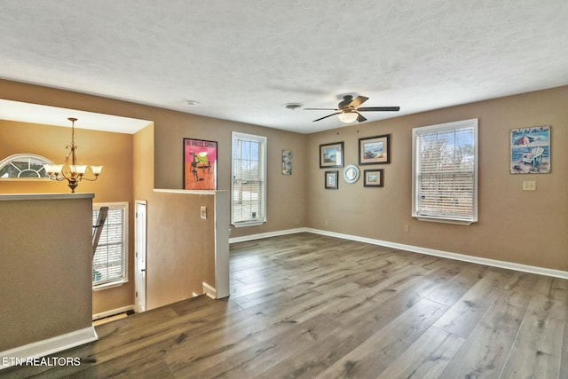 interior space featuring a textured ceiling, hardwood / wood-style floors, and ceiling fan with notable chandelier