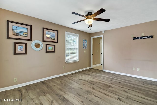 empty room featuring hardwood / wood-style flooring and ceiling fan