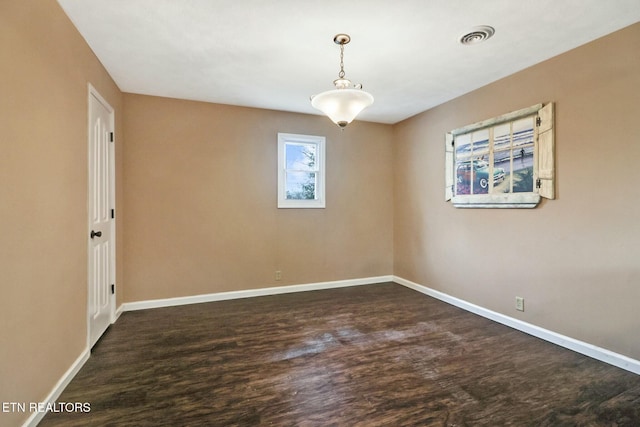 unfurnished room featuring dark wood-type flooring