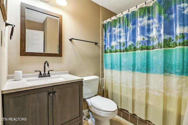 bathroom with vanity, toilet, and walk in shower