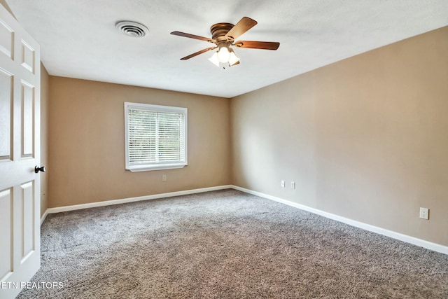 spare room featuring carpet flooring and ceiling fan