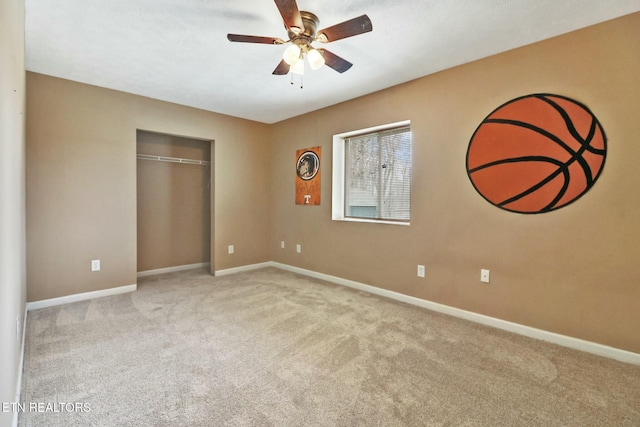 unfurnished bedroom with light carpet, a closet, and ceiling fan