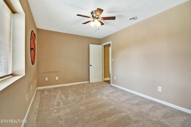 carpeted empty room with ceiling fan