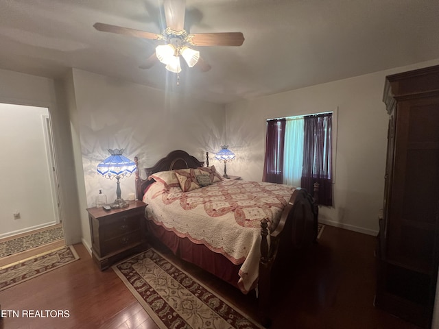 bedroom with ceiling fan and dark hardwood / wood-style floors