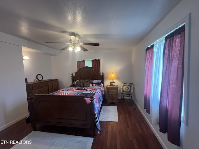 bedroom with ceiling fan and dark hardwood / wood-style flooring