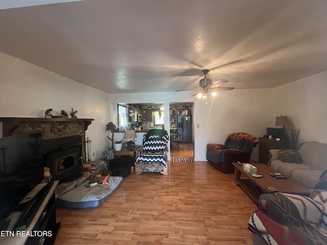 living room with ceiling fan and light hardwood / wood-style flooring