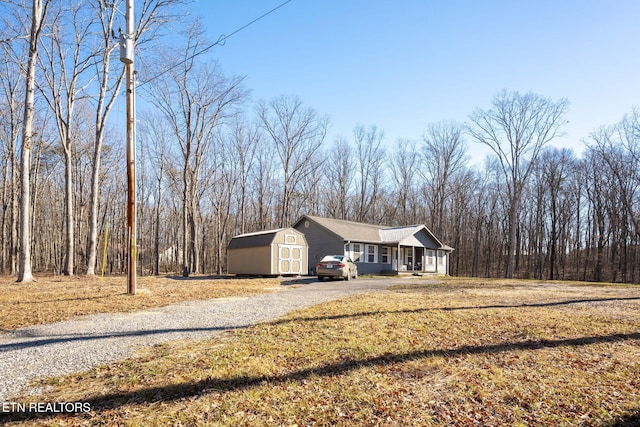 view of front of property with a porch and a storage shed