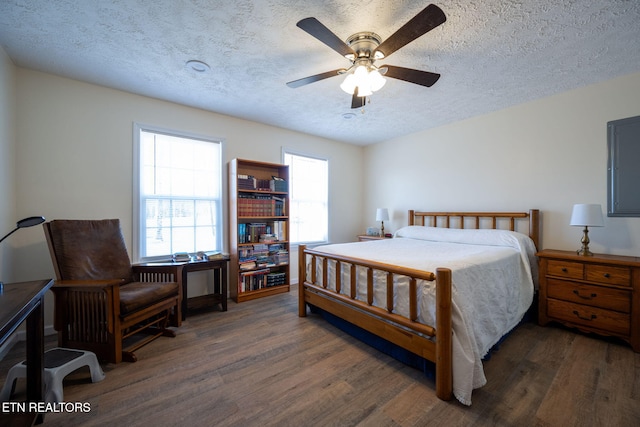 bedroom featuring a textured ceiling, dark hardwood / wood-style flooring, and ceiling fan