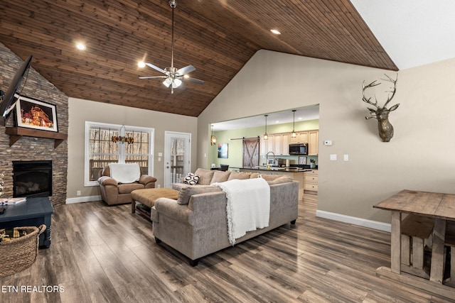 living room featuring wood ceiling, a stone fireplace, ceiling fan, high vaulted ceiling, and dark hardwood / wood-style floors