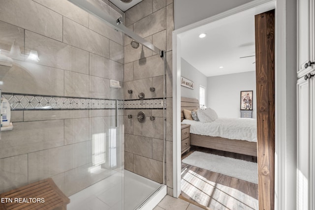 bathroom featuring a shower with door and tile patterned floors