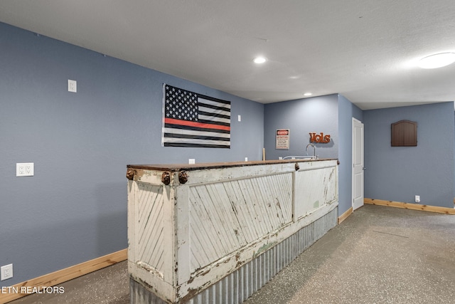 bar featuring a textured ceiling