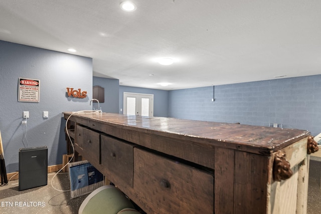 interior space featuring sink, french doors, and dark brown cabinetry