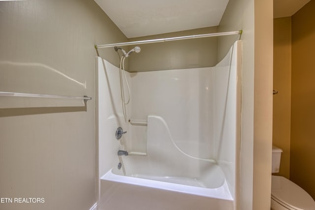 bathroom featuring toilet and tub / shower combination