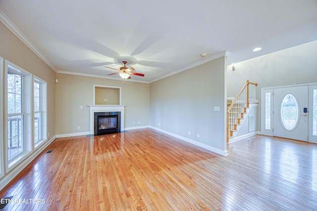 unfurnished living room featuring light hardwood / wood-style floors, ceiling fan, and ornamental molding