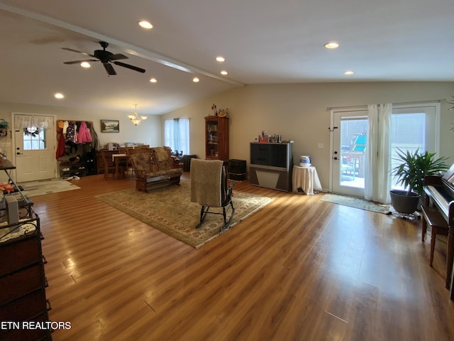 living room with lofted ceiling, plenty of natural light, and hardwood / wood-style floors