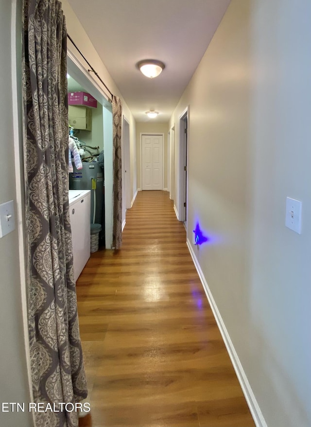 hall featuring hardwood / wood-style floors and water heater