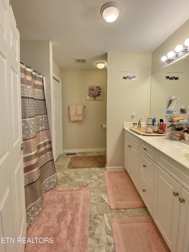 bathroom with vanity and curtained shower