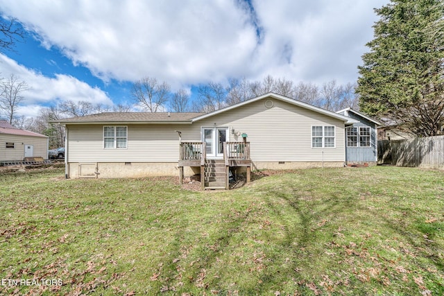 back of property with a deck, fence, a yard, stairway, and crawl space