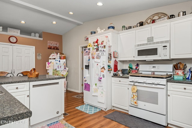 kitchen with light wood-style floors, dark countertops, white appliances, and white cabinets