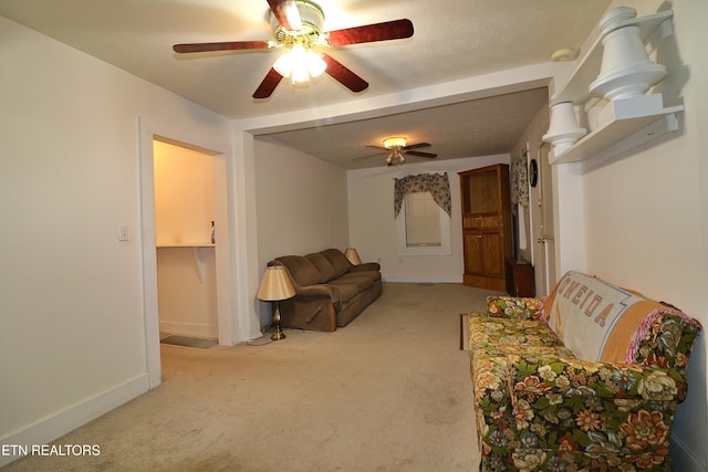 carpeted living room with ceiling fan