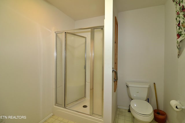 bathroom featuring walk in shower and toilet