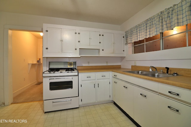 kitchen featuring white cabinetry, sink, and gas range gas stove