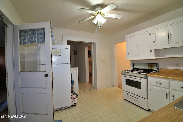 kitchen with ceiling fan, white appliances, and white cabinets