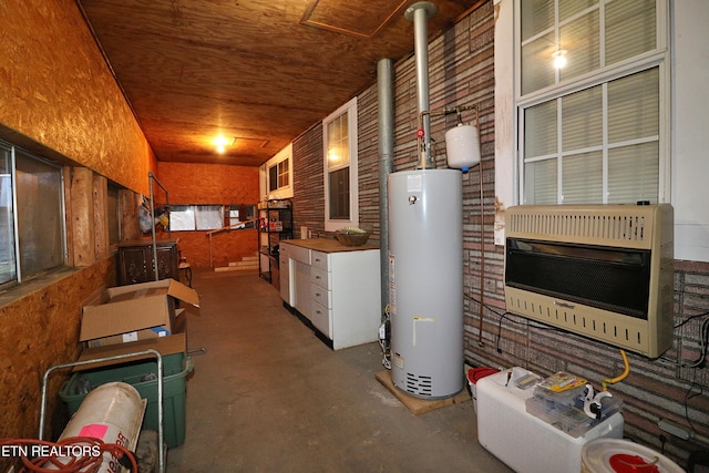 basement with wood ceiling, heating unit, and gas water heater