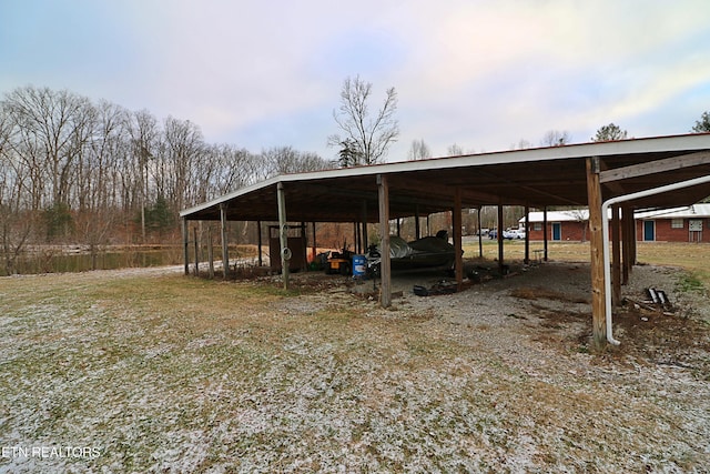 view of parking / parking lot featuring a carport