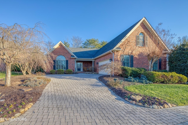 front facade with a front yard and a garage